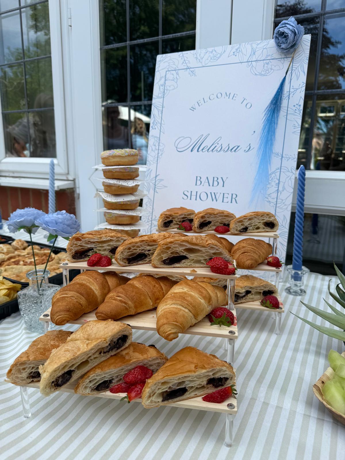 Baby shower pastry stand with croissants and strawberries