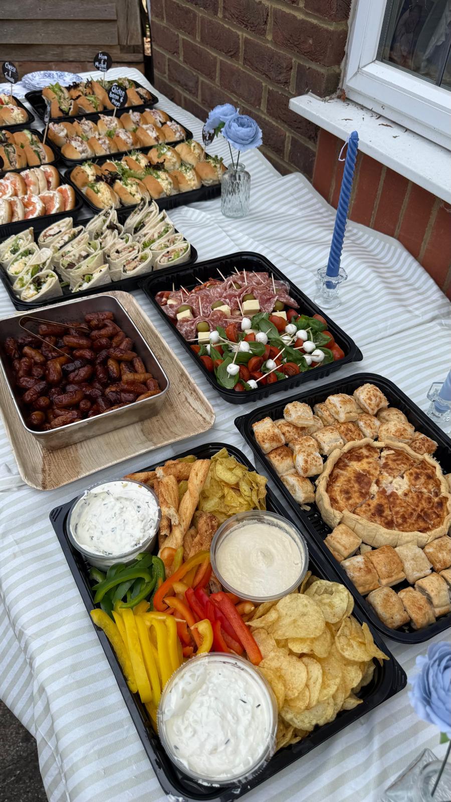 Catering platters with sandwiches, wraps and dips